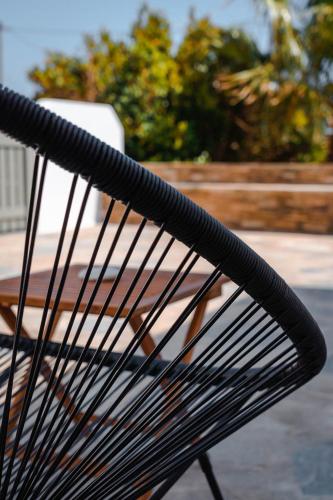 a close up of a black bench in a park at Living Blue Tinos in Kardiani