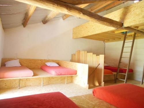 a room with two bunk beds in a attic at Gite d'étape saisonnier Làô Refuge in La Charité-sur-Loire