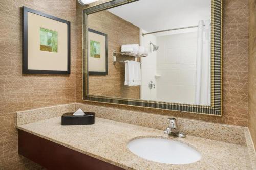 a bathroom with a sink and a large mirror at Holiday Inn Express Boston Brockton by IHG in Brockton
