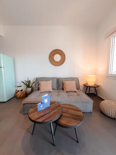 a living room with a couch and a table at Living Blue Tinos in Kardiani