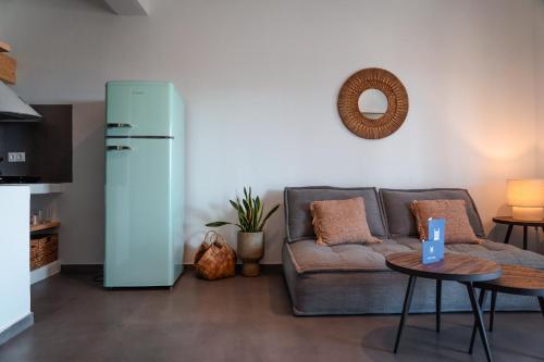 a living room with a couch and a refrigerator at Living Blue Tinos in Kardiani