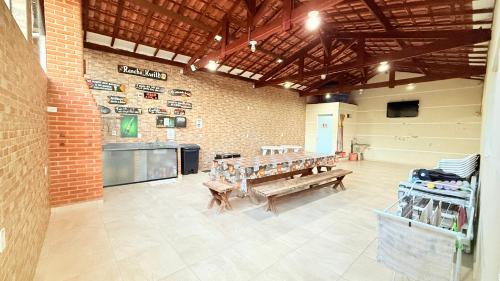 a large room with benches in a brick building at RANCHO KWILL in Serra Negra