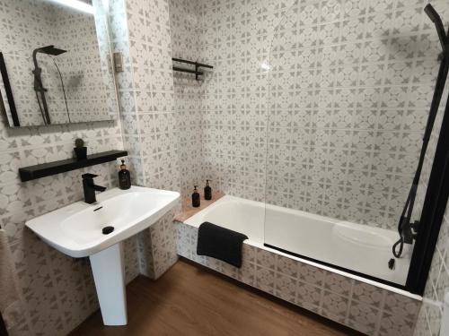 a bathroom with a sink and a bath tub at La Casa de la Abuela Boticaria in Redondela