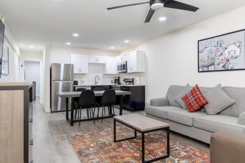 a living room with a couch and a kitchen at The Fold Hotels Steamboat Springs in Steamboat Springs