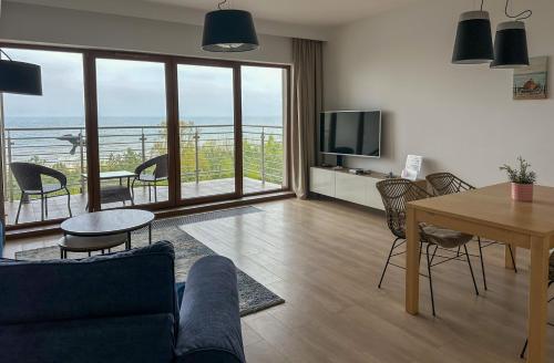 a living room with a couch and a table at FEWO Sea View East Tower Porta Mare in Dziwnówek