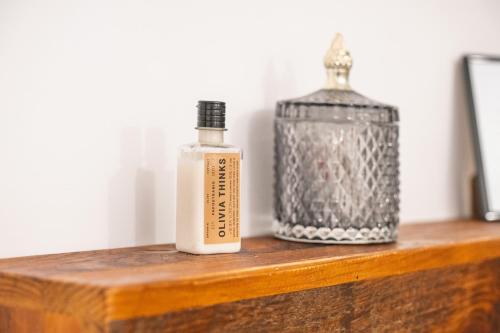 a bottle of soap and a container on a wooden shelf at Dimora Storica Villa Pasquale Capri in Capri