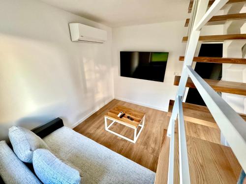 a living room with a couch and a tv at Agroturystyka Domki za Lipą in Lubawka