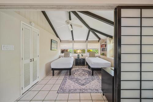 a room with two beds and a living room at International Colony Club 43 · ICC 43 Spacious 2BD Cottage Walk in Lahaina