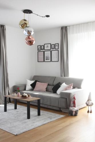 a living room with a couch and a table at Rio Vita with garage parking in Rijeka