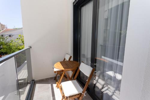 a small balcony with a table and chairs on it at Apartments Ivo Herceg Novi in Herceg-Novi