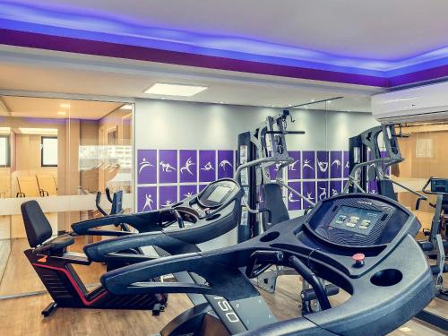 a gym with three cardio machines in a room at Flat Nações Unidas SP Limpeza Diária in Sao Paulo