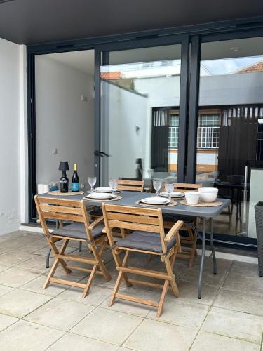 a dining table and chairs on a patio at Casa da Beira Mar in Aveiro