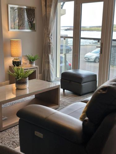 a living room with a couch and a coffee table at Atlantic Port Retreat in Portstewart