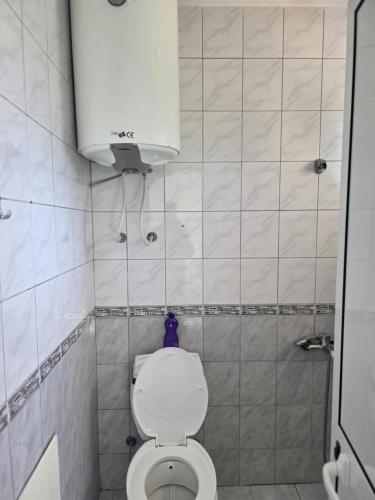 a small bathroom with a toilet and a cabinet at SHARRI Apartments in Ulcinj