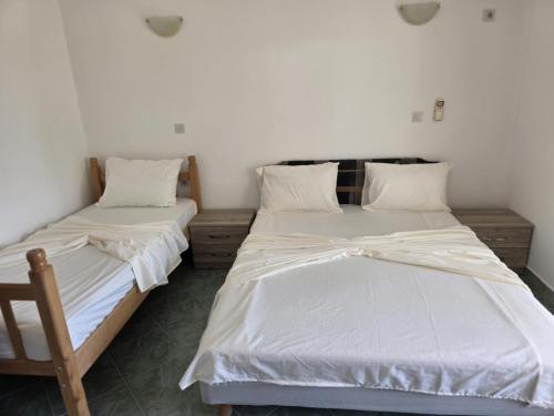 two beds sitting next to each other in a room at SHARRI Apartments in Ulcinj