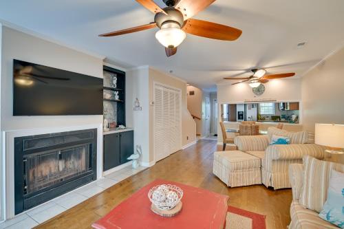 a living room with a fireplace and a ceiling fan at Coastal Vacation Rental - 2 Mi to Huntington Beach in Myrtle Beach