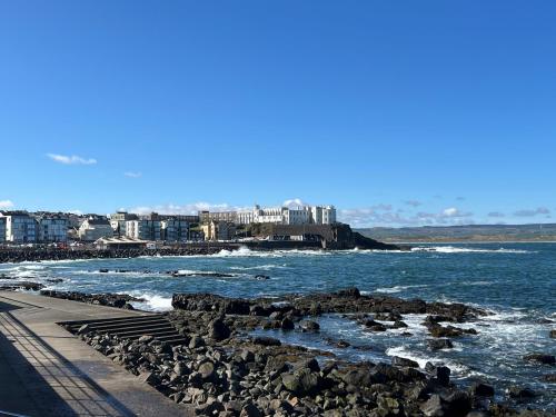 a view of the ocean from a rocky beach at Atlantic Port Retreat in Portstewart