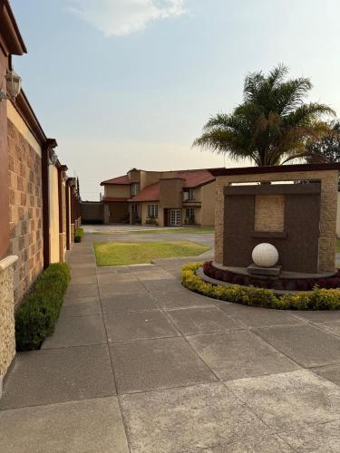a building with a palm tree next to a sidewalk at Chalets Dannis in Contla