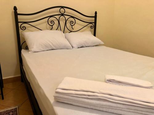 a bed with two pillows and two towels on it at Luxury Villa Riad Style - WIFI & PARKING in Agadir