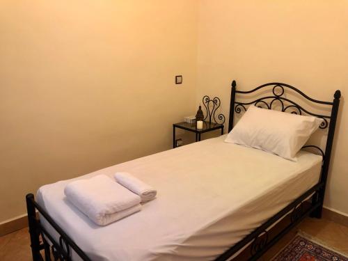 a bedroom with a bed with two towels on it at Luxury Villa Riad Style - WIFI & PARKING in Agadir