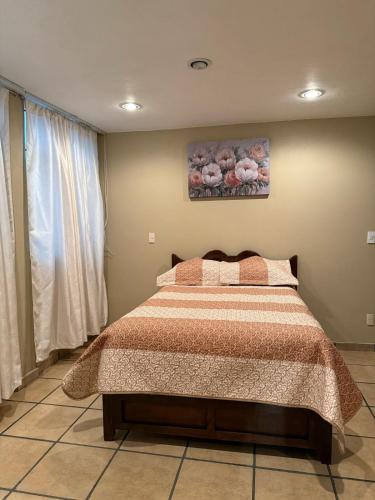 a bedroom with a bed and a painting on the wall at Chalets Dannis in Contla