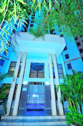 an image of a building with trees in front of it at Cozy Home Near Wilson Airport & Giraffe Center in Nairobi