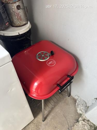 a red suitcase sitting next to a wall at New! Mini Casa de Playa in Arecibo