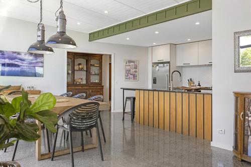 a kitchen and dining room with a table and chairs at Elevated Taupo Hideaway With Views and Designer Comfort in Taupo