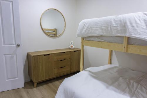 a bedroom with a bunk bed and a mirror at Brand New Backyard Guest House in Werribee CBD in Werribee