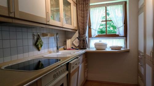 a kitchen with a sink and a window at "Allgäuglück", Oberstaufen in Oberstaufen