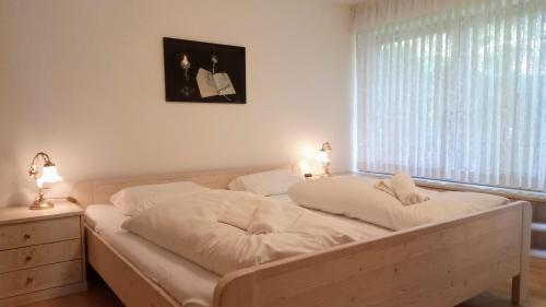a bedroom with two beds and a window at "Allgäuglück", Oberstaufen in Oberstaufen
