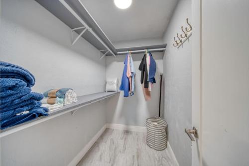 a walk in closet with blue towels on a shelf at Lighthouse Retreat With A Pool in Ponce Inlet