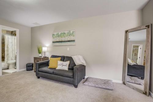 a living room with a couch and a mirror at Mountain Studio Cozy Escape with Stunning Views in Cascade-Chipita Park