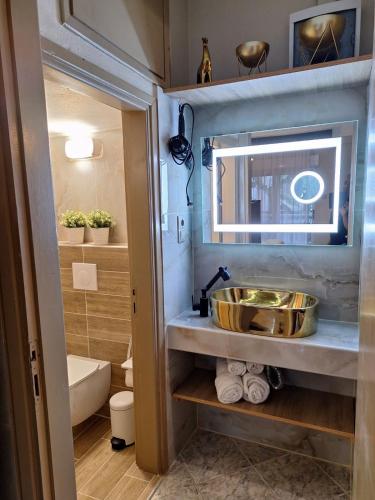 a bathroom with a sink and a tub at Sammys apartments in Nea Potidaea