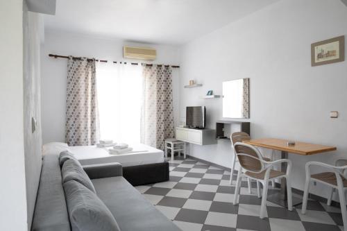 a living room with a couch and a table at NMS Apartments in Ksamil