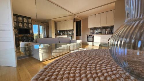 Il comprend un grand salon avec des canapés et une cuisine. dans l'établissement Grand appartement avec vue sur la fontaine de la Rotonde, à Aix-en-Provence