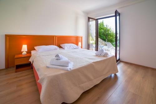 a bedroom with a large bed with towels on it at Oasis Premium Twin in Primošten