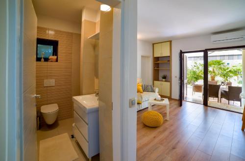 a bathroom with a sink and a toilet in a room at Oasis Premium Twin in Primošten