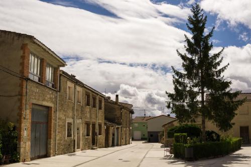 an empty street with a christmas tree next to buildings at Antojos in Tardajos
