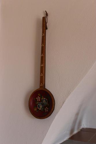 a wooden spoon is hanging on a wall at A BeautifuL Terrace on Paradise Imperia - by HOST4U in Montegrazie