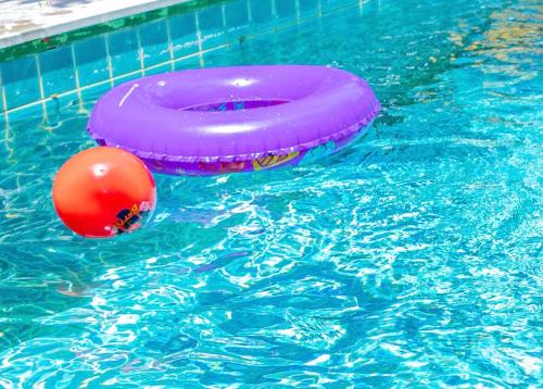 a pink frisbee and a ball in a swimming pool at Chiang Ron in Chiang Mai