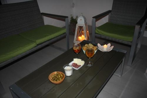a table with two beds and two glasses of wine at One More Night in Fregene