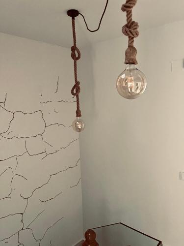 a room with two lights hanging from a wall at Antojos in Tardajos