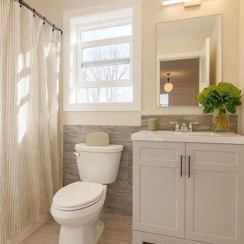 a white bathroom with a toilet and a sink at Westville Haven Modern 2BR Near Yale in New Haven