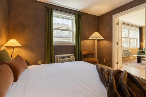 a bedroom with a large bed and a window at Westville Haven Modern 2BR Near Yale in New Haven