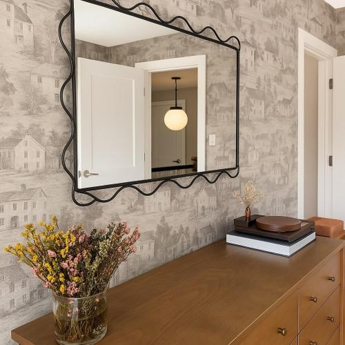 a mirror on a wall above a dresser with flowers at Westville Haven Modern 2BR Near Yale in New Haven