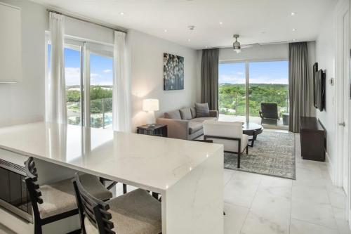 a living room with a white table and chairs at One bedroom condo at ONE Cable Beach in Nassau