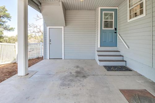 a front door of a white house with a blue door at Walk to Dtwn Show Low Townhome with Balcony in Show Low