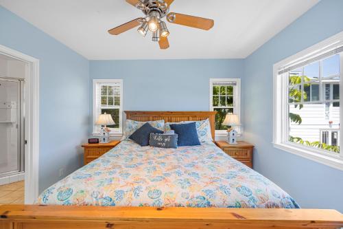 a bedroom with a bed with blue walls and a ceiling fan at 217BA 217 Beacon A in Avalon