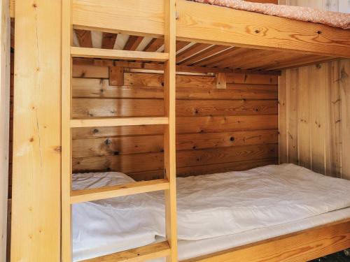 a wooden bunk bed in a wooden cabin at 6 person holiday park home in Gørlev in Gørlev